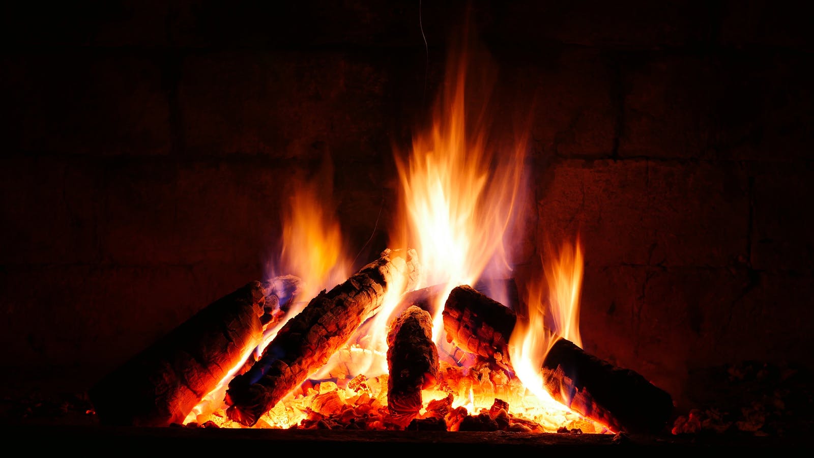 A cosy indoor fireplace burning seasoned firewood